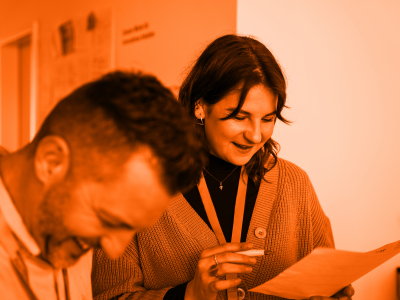 Foto von zwei Personen, die über einen Formular sprechen